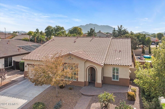 mediterranean / spanish home featuring a mountain view and a patio