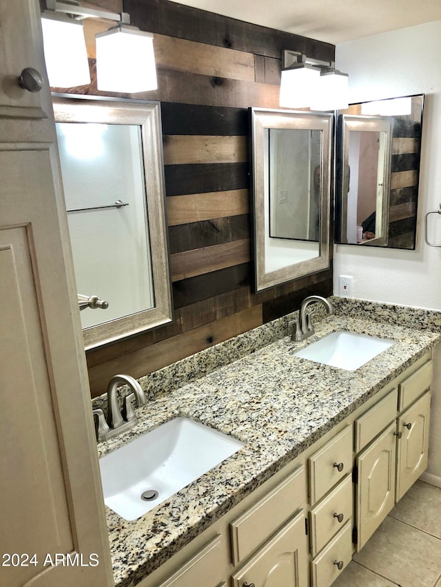 bathroom featuring tile patterned flooring, vanity, and wooden walls