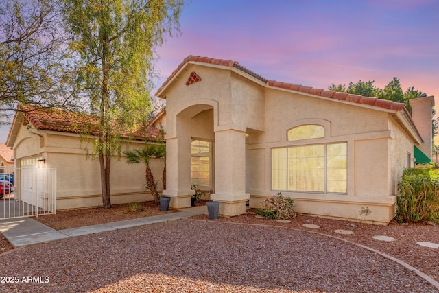 mediterranean / spanish-style house featuring a garage