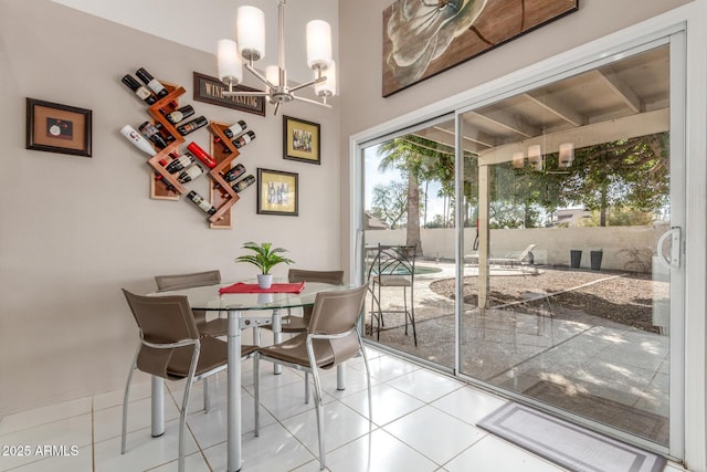 tiled dining space featuring a chandelier