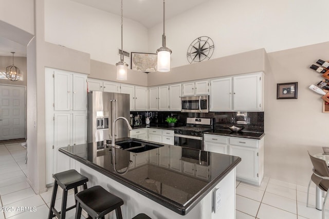 kitchen featuring white cabinetry, sink, a kitchen island with sink, and stainless steel appliances