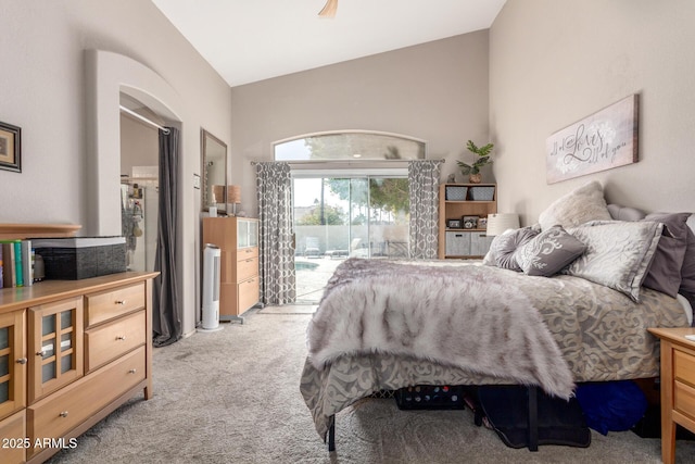 carpeted bedroom featuring lofted ceiling and access to outside