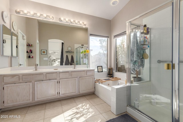 bathroom featuring lofted ceiling, vanity, independent shower and bath, and tile patterned flooring