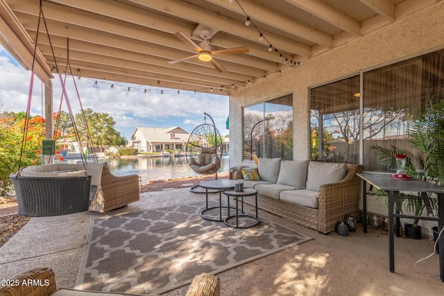 view of patio featuring a water view, an outdoor hangout area, and ceiling fan