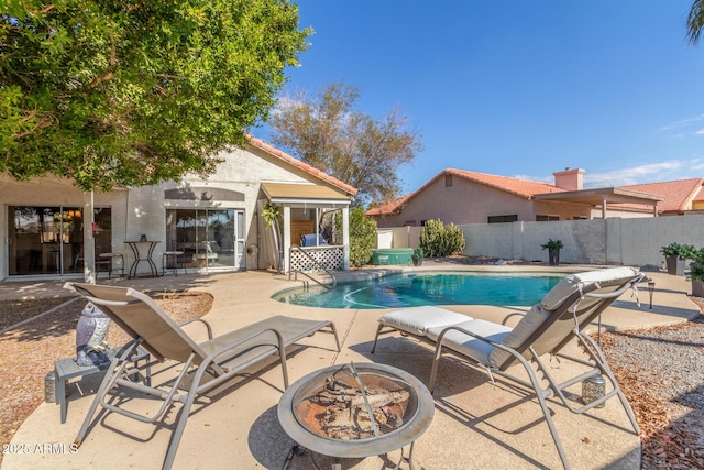 view of pool with a fire pit and a patio area