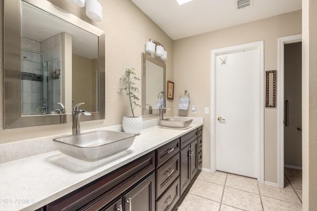 bathroom featuring an enclosed shower, vanity, and tile patterned flooring