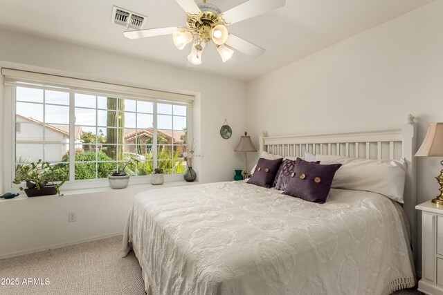 bedroom with light carpet and ceiling fan