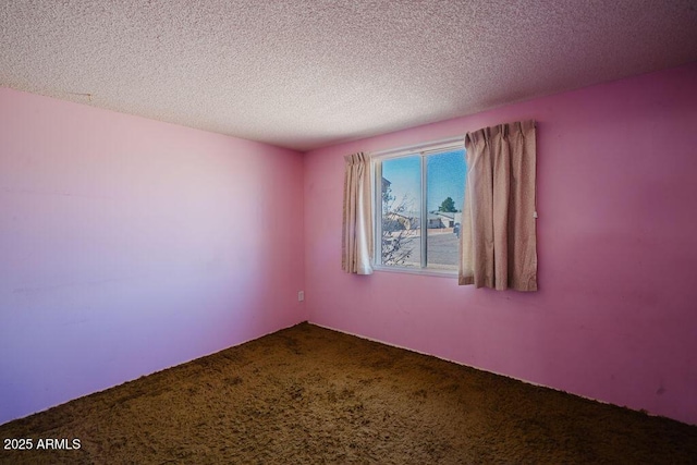 carpeted spare room featuring a textured ceiling