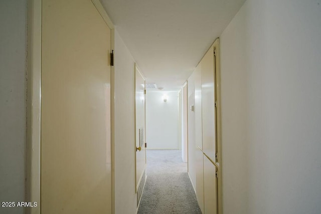 hall featuring light colored carpet