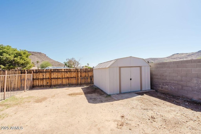 view of shed featuring a mountain view and a fenced backyard