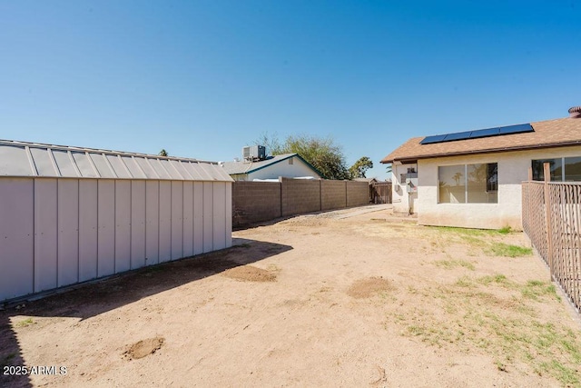 view of yard featuring an outdoor structure and a fenced backyard