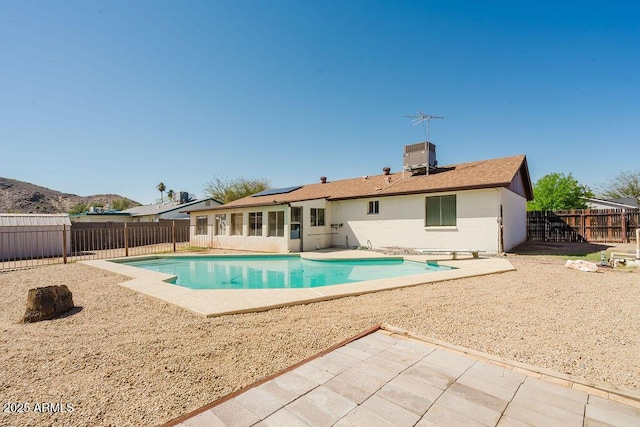 view of swimming pool with a fenced in pool, a patio, a fenced backyard, and central air condition unit