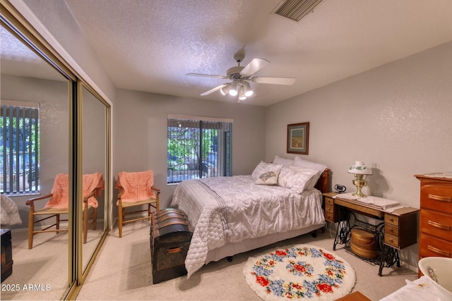 bedroom with ceiling fan, a closet, visible vents, and light colored carpet