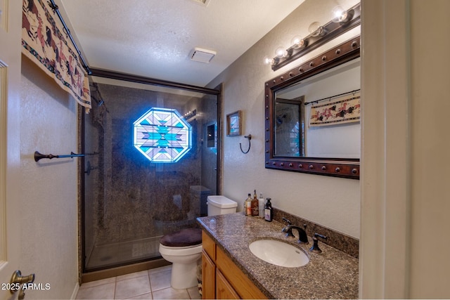 full bathroom with a stall shower, vanity, toilet, and tile patterned floors