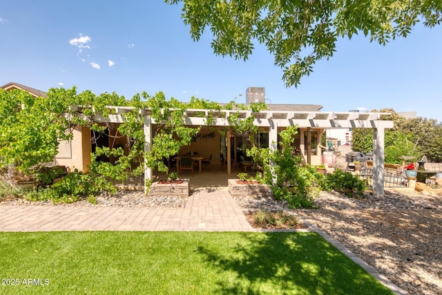 back of house with a yard, a patio, a pergola, and stucco siding
