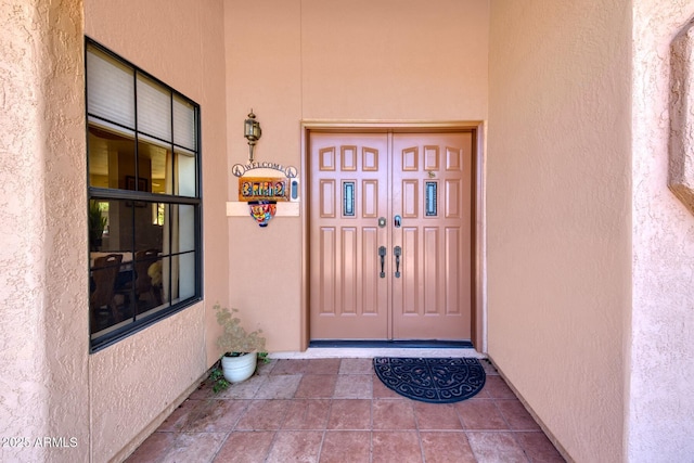 property entrance with stucco siding