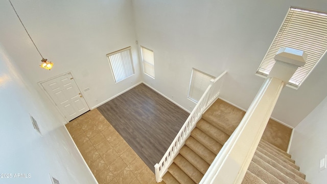 7425 W Crown King Rd, Phoenix, AZ 85043 - entrance foyer featuring baseboards, a high ceiling, stairway, and a healthy amount of sunlight