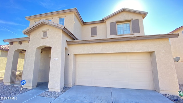 7425 W Crown King Rd, Phoenix, AZ 85043 - view of front facade with stucco siding, an attached garage, concrete driveway, and a tiled roof