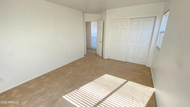 7425 W Crown King Rd, Phoenix, AZ 85043 - unfurnished bedroom with a closet, baseboards, and light carpet