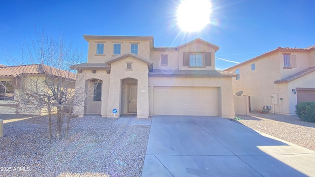 7425 W Crown King Rd, Phoenix, AZ 85043 - mediterranean / spanish home featuring an attached garage, driveway, and stucco siding