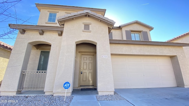 7425 W Crown King Rd, Phoenix, AZ 85043 - view of front facade featuring a garage, a tile roof, concrete driveway, and stucco siding