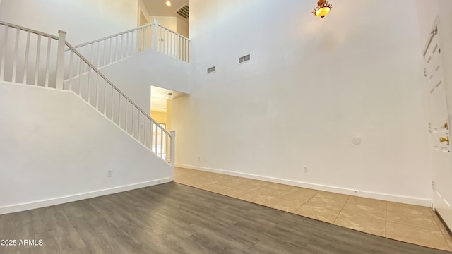 7425 W Crown King Rd, Phoenix, AZ 85043 - unfurnished living room featuring visible vents, wood finished floors, and stairs