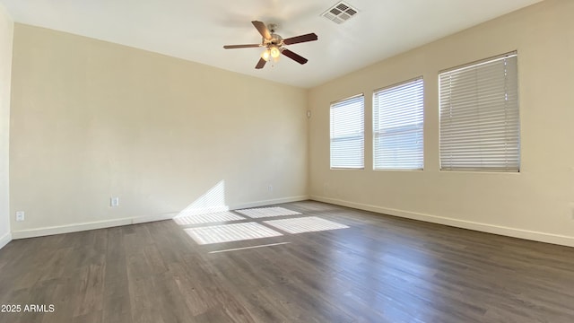 7425 W Crown King Rd, Phoenix, AZ 85043 - unfurnished room with dark wood finished floors, visible vents, a ceiling fan, and baseboards