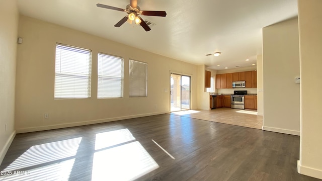 7425 W Crown King Rd, Phoenix, AZ 85043 - unfurnished living room featuring wood finished floors, a ceiling fan, and baseboards