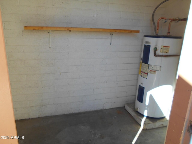 interior space with water heater and concrete block wall