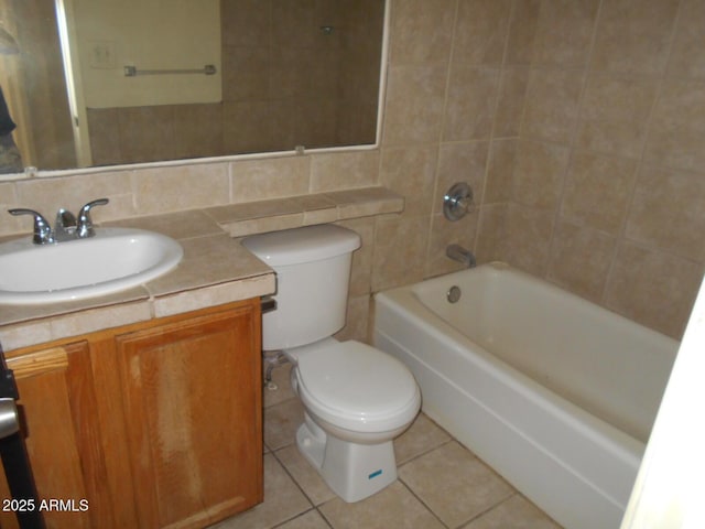 full bathroom with tile patterned floors, toilet, backsplash, tile walls, and vanity