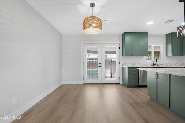 3607 N 79th Ave, Phoenix, AZ 85033 - kitchen featuring green cabinets, french doors, light wood finished floors, baseboards, and decorative light fixtures