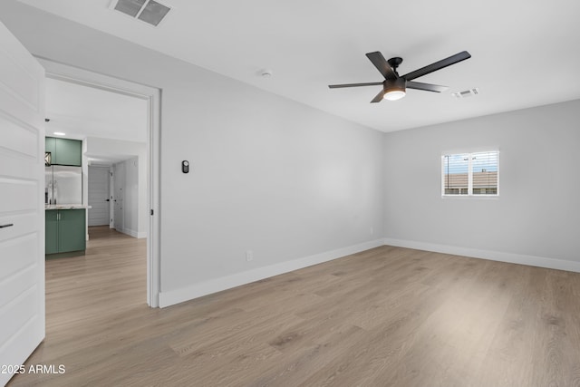 3607 N 79th Ave, Phoenix, AZ 85033 - spare room featuring a ceiling fan, light wood-style flooring, and baseboards