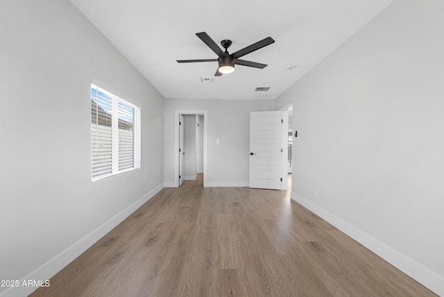 3607 N 79th Ave, Phoenix, AZ 85033 - unfurnished room with wood finished floors, a ceiling fan, and baseboards