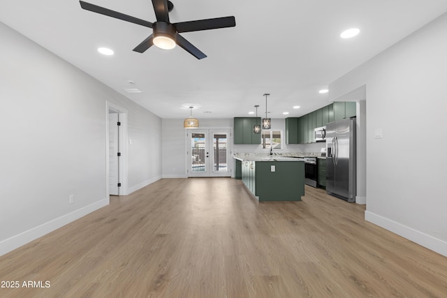3607 N 79th Ave, Phoenix, AZ 85033 - kitchen featuring green cabinets, appliances with stainless steel finishes, light countertops, baseboards, and ceiling fan