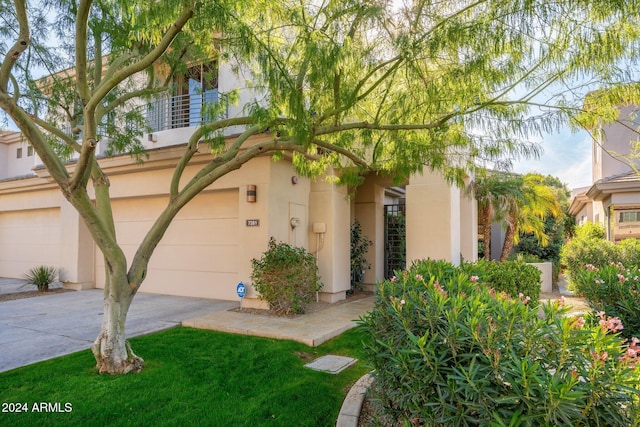 view of front of property with a balcony and a garage