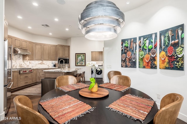 dining area with hardwood / wood-style flooring and washing machine and clothes dryer