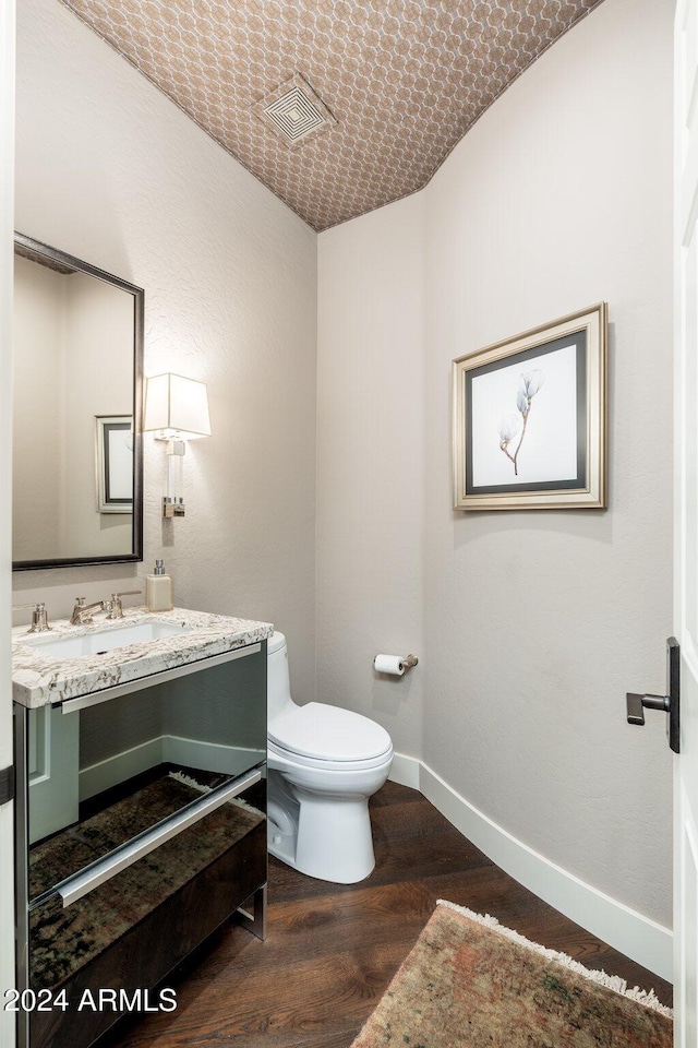 bathroom featuring hardwood / wood-style floors, vanity, and toilet