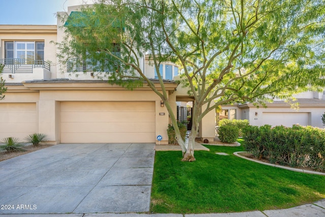 view of front of house featuring a garage and a front lawn