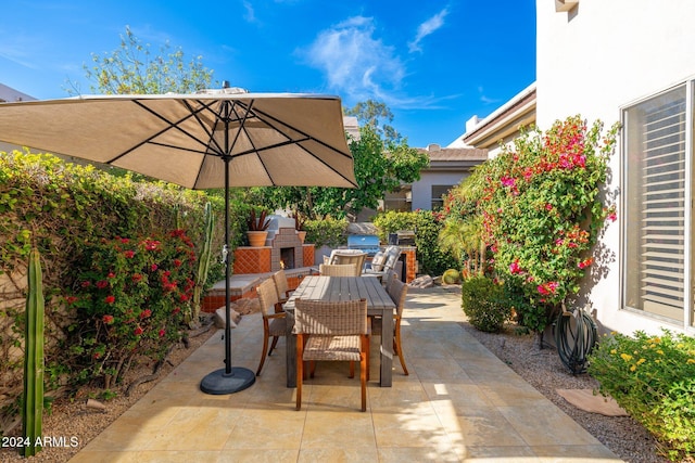 view of patio featuring an outdoor stone fireplace