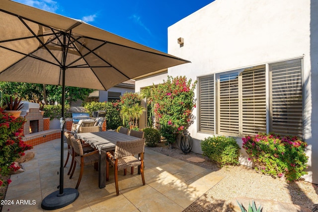 view of patio / terrace with an outdoor brick fireplace