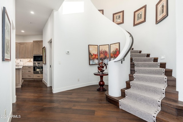 staircase with hardwood / wood-style floors