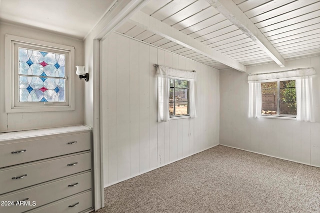 interior space featuring beam ceiling and carpet