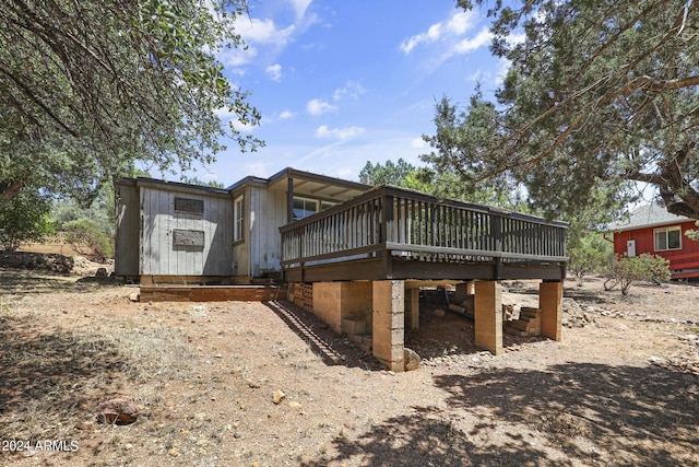 view of property exterior with a wooden deck