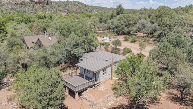 bird's eye view with a wooded view