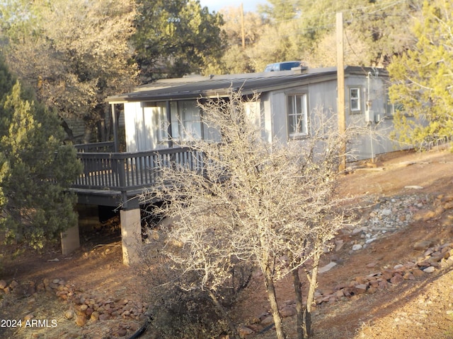 back of house featuring a wooden deck