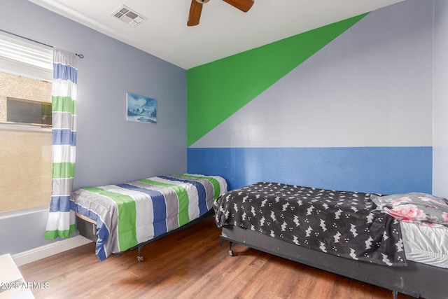 bedroom with hardwood / wood-style flooring and ceiling fan