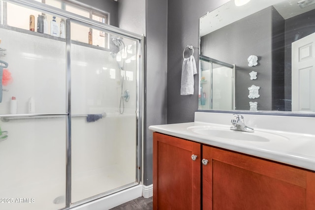 bathroom with vanity and a shower with shower door