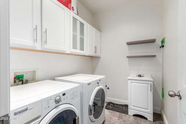 washroom with cabinets and washer and clothes dryer