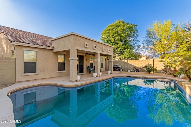 view of pool featuring ceiling fan and a patio area