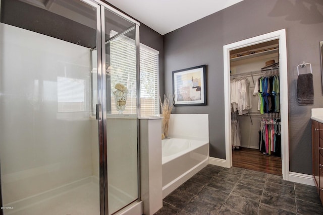 bathroom featuring vanity and plus walk in shower